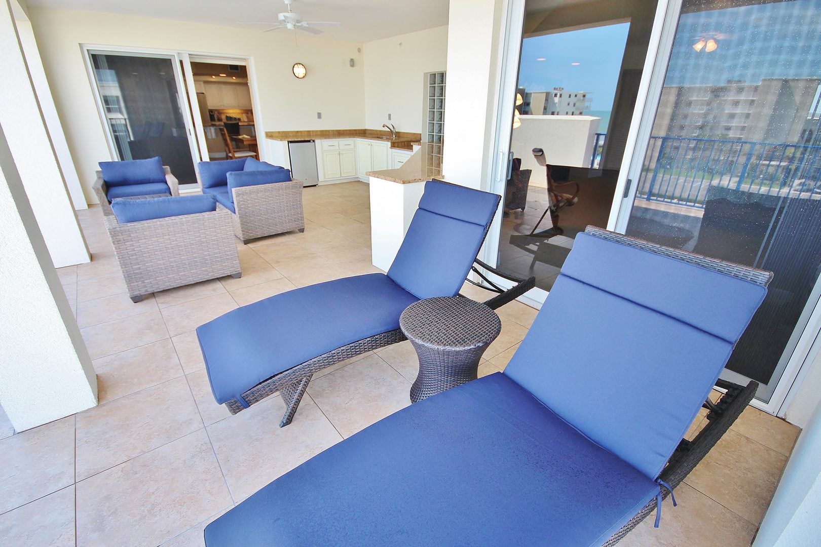 Large balcony area with lounge chairs