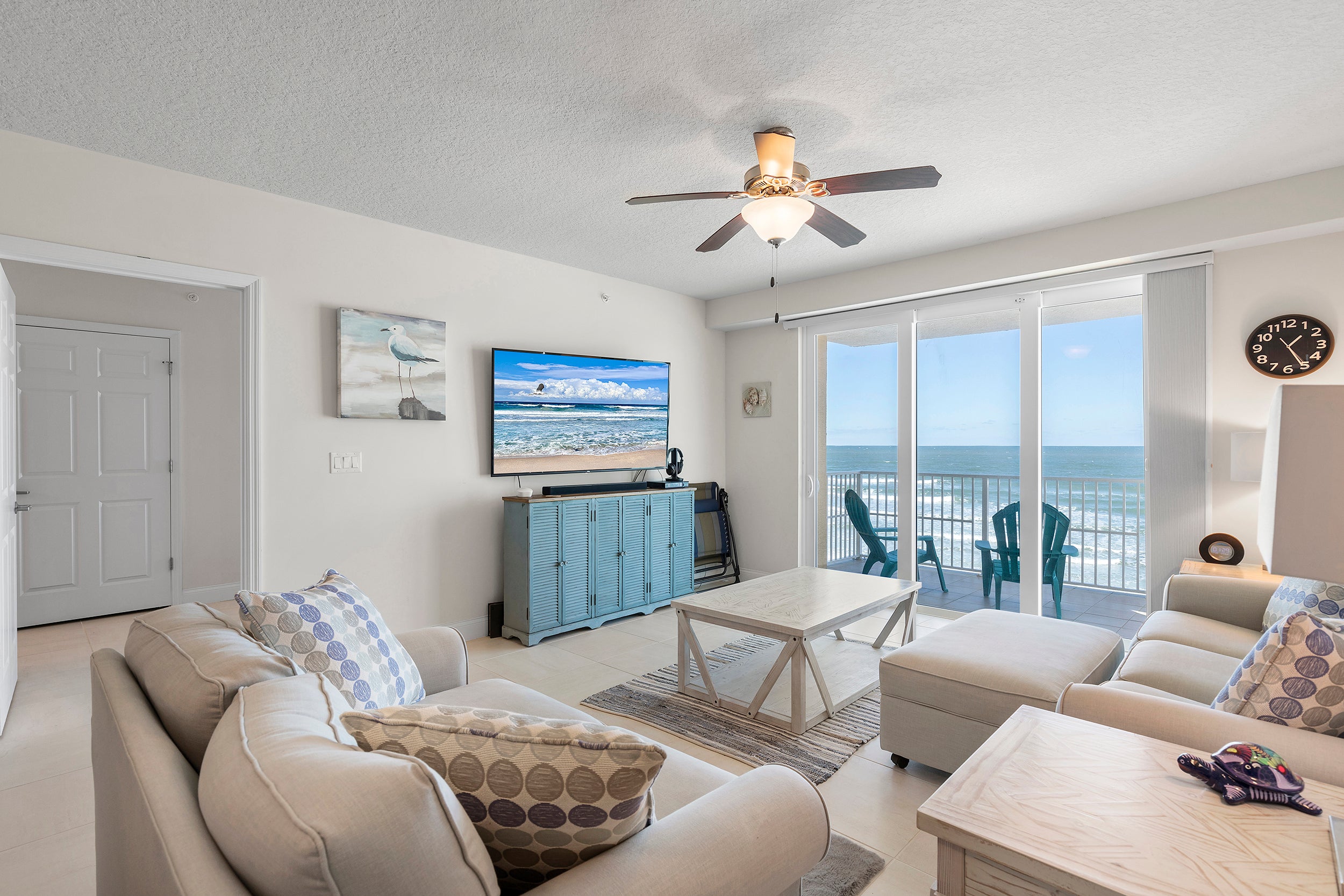 Relax in living room with large TV and ocean views