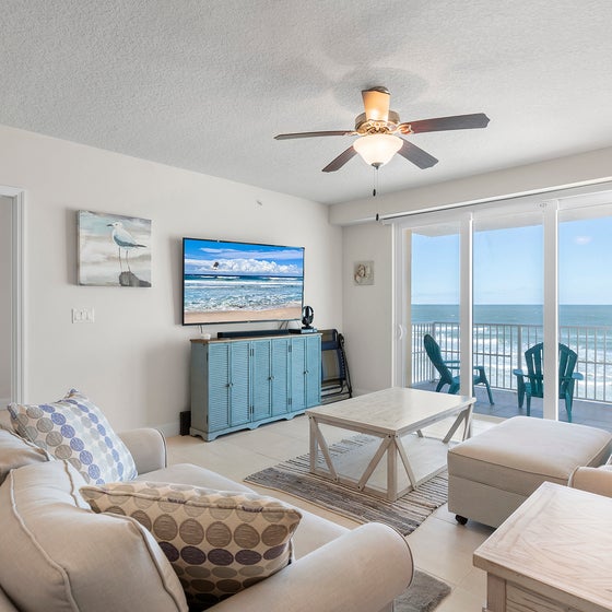 Relax in living room with large TV and ocean views